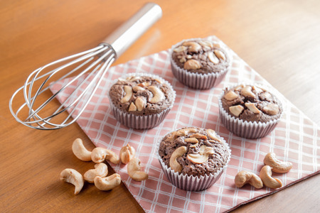 Cup of Chocolate Cake Brownies With Cashew nuts On Wooden Backgroundの写真素材