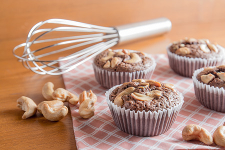 Cup of Chocolate Cake Brownies With Cashew nuts On Wooden Backgroundの写真素材