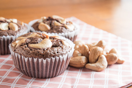 Cup of Chocolate Cake Brownies With Cashew nuts On Wooden Backgroundの写真素材