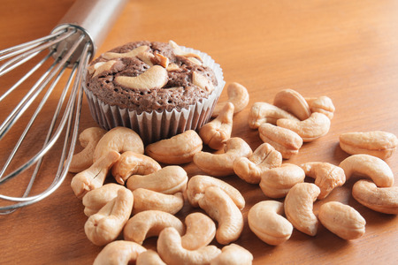 Cup of Chocolate Cake Brownies With Cashew nuts On Wooden Backgroundの写真素材