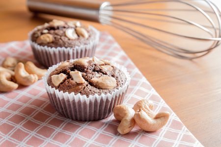 Cup of Chocolate Cake Brownies With Cashew nuts On Wooden Backgroundの写真素材