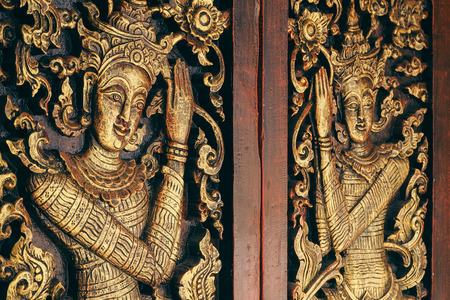 Thai Wooden Sculpture Male Angle On Temple Doorの写真素材
