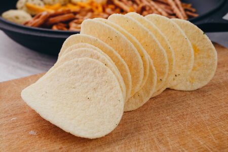 Potato chips on a kitchen board closeupの写真素材