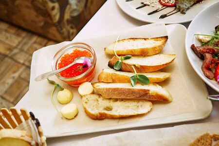 Red caviar with toasted bread croutons on a banquet table close-up.の写真素材