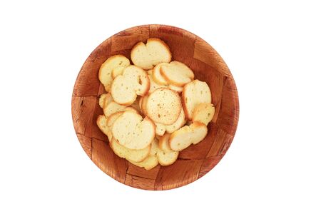 Croutons bread crisps in a wooden plate isolated on white backgroundの写真素材