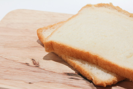 Brown bread slice on chopping woodの写真素材