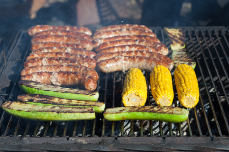 Fry the sausages and vegetables on barbecueの写真素材