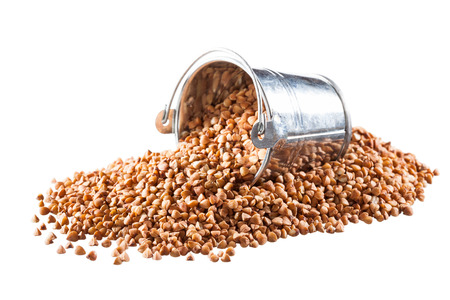 Buckwheat groats in a bucket on a white backgroundの写真素材
