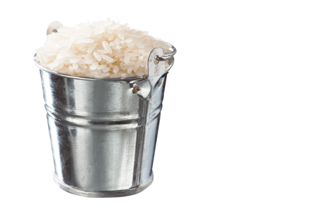 Rice in a bucket on a white backgroundの写真素材