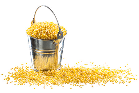 Millet in a bucket on a white backgroundの写真素材