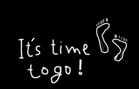It is time to go! hand writing footprints and words on blackboardの写真素材