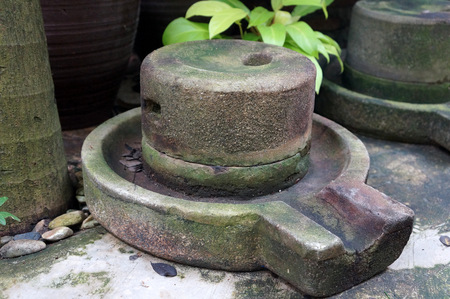 Thailand; The Ancient grain grinding millstones with handle used to make wheat isolated on white backgroundの写真素材