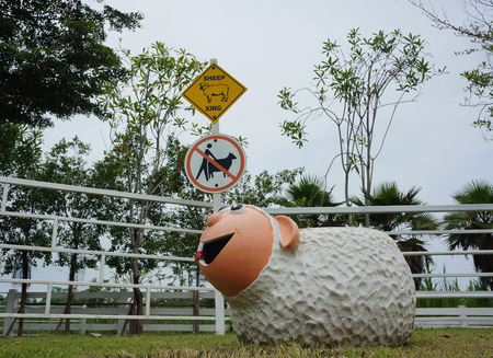 Sheep statue smile on the grass.の写真素材
