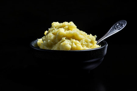 Delicious creamy mashed potatoes with butter, fresh herbs and freshly-cracked black pepperの素材