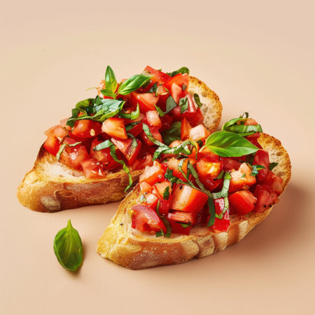 Closeup of two slices of bruschetta topped with diced tomatoes and fresh basil, on a beige background. Delicious Italian appetizer or snack.の素材
