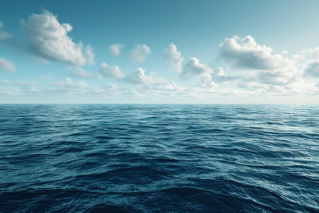A tranquil seascape featuring a vast expanse of blue ocean water gently rippling under a bright sky with white clouds.の素材