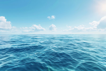 A serene seascape with blue water and white clouds against a clear blue sky.の素材