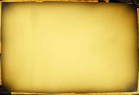 A close-up view of an old, yellowed paper texture with a grunge border surrounding a blank, central area.の素材