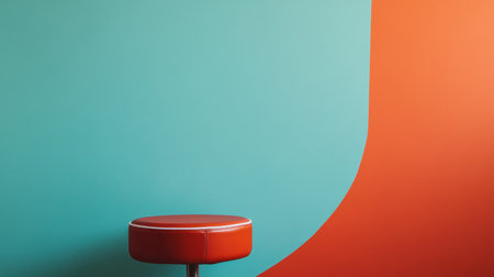 A red stool sits against a teal and orange wall.の素材