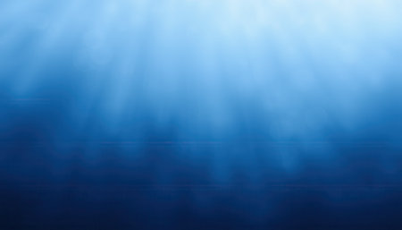 An abstract image depicting the deep blue ocean with sunlight rays penetrating the water creating a serene underwater scene.の素材