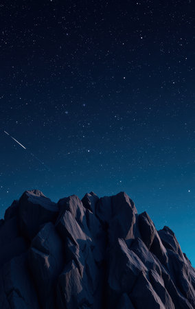 A dark mountain range silhouetted against a vibrant night sky filled with stars and a shooting star.の素材