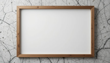 Light wooden picture frame with a blank white canvas, set against a textured gray background, perfect for showcasing a graphic design.の素材
