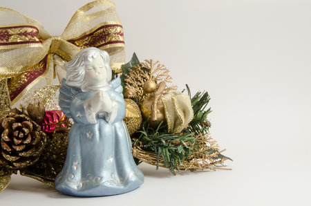 Angel statue with christmas decoration on white backgroundの写真素材