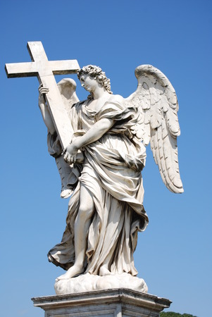 Bernini marble statue of angel with cross from the Sant Angelo Bridge in Romeの写真素材