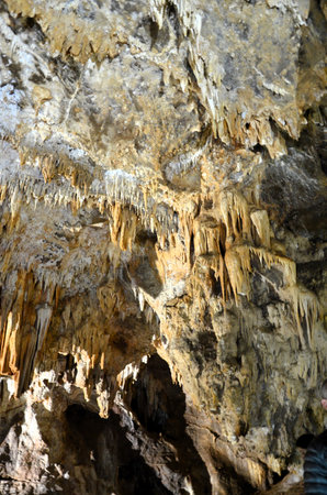 Inside of beautiful old dark cave with many stalactites. Caves of Is Zuddas, Italy, Sardiniaの写真素材