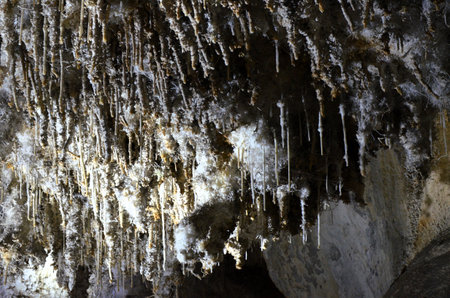 Inside of beautiful old dark cave with many stalactites. Caves of Is Zuddas, Italy, Sardiniaの写真素材