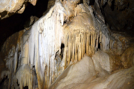 Inside of beautiful old dark cave with many stalactites. Caves of Is Zuddas, Italy, Sardiniaの写真素材