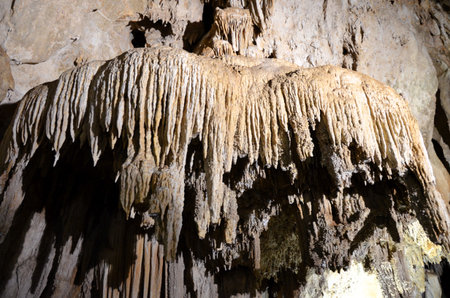 Inside of beautiful old dark cave with many stalactites. Caves of Is Zuddas, Italy, Sardiniaの写真素材