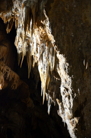 Inside of beautiful old dark cave with many stalactites. Caves of Is Zuddas, Italy, Sardiniaの写真素材