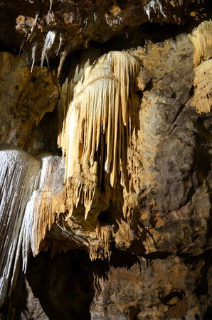 Inside of beautiful old dark cave with many stalactites. Caves of Is Zuddas, Italy, Sardiniaの写真素材