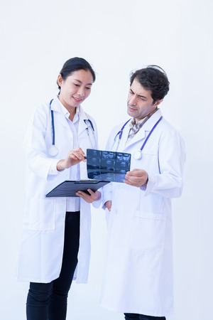 Medical worker working at hospital,Medical Group of multi-ethnic doctors discussing and looking x-ray in a clinicの写真素材