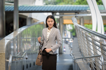 business woman standing and hand holding a bag office conceptの写真素材