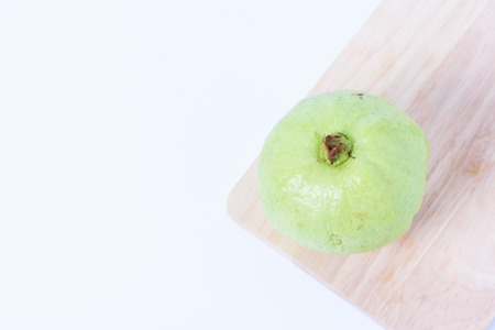 Guava isolated on wood with white backgroundの写真素材