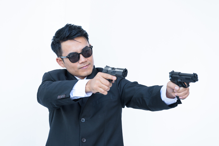 Bodyguard with pistol in hands Isolated on white backgroundの写真素材