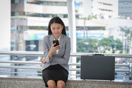 business woman play social media waiting time to work dayの写真素材