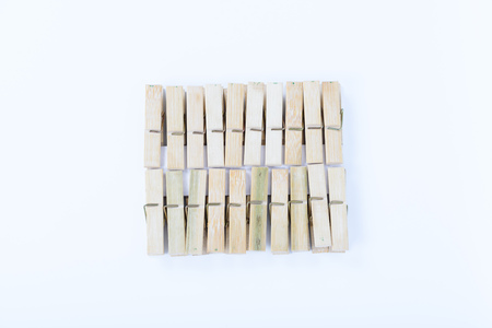 wooden cloth pegs isolated on white backgroundの写真素材