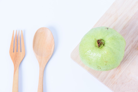 Guava isolated and fork and wooden spoon on white backgroundの写真素材