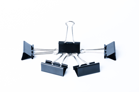 Black old metal binder paper clip for document on white backgroundの写真素材