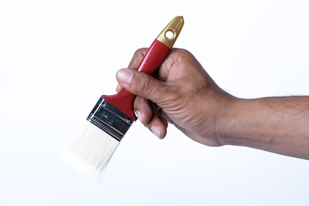 hand on red paintbrush isolated on white backgroundの写真素材