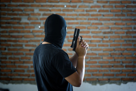 criminal hand holding shot gun  inside building structure, stealth conceptの写真素材