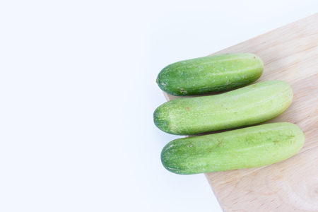 Cucumber over wood  isolated on white backgroundの写真素材