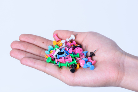 hand holding pins for note paper on white backgroundの写真素材