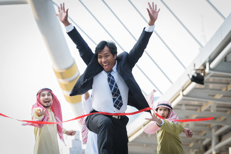 businessman winning competitors arab officeman crosses the finish line, concept  finish achieving accomplishmentの写真素材