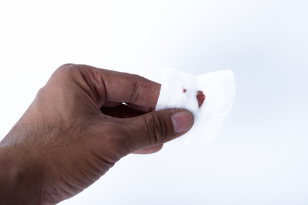 on hand Bloody cotton with white backgroundの写真素材
