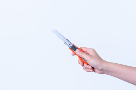 hand holding  Colorful plastic Cutter isolated on white backgroundの写真素材