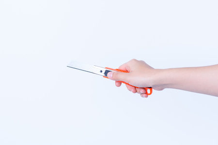 hand holding  Colorful plastic Cutter isolated on white backgroundの写真素材